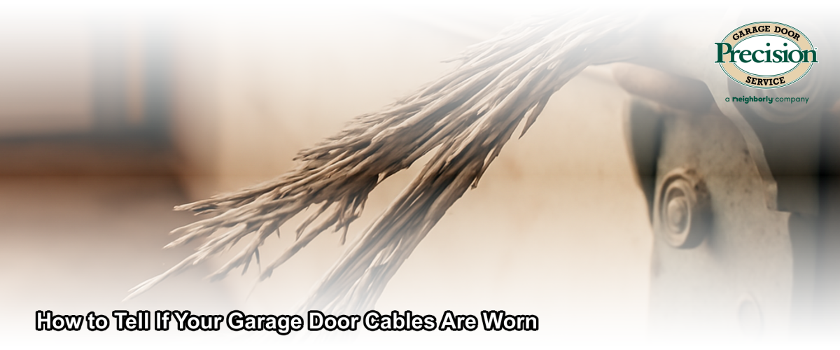 Close-up of frayed and worn garage door lift cables on a residential garage door in Chicago, IL