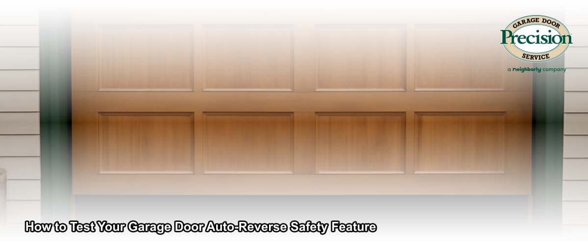 A technician testing a garage door auto-reverse safety feature by placing a wooden board flat on a concrete garage floor beneath a closing door