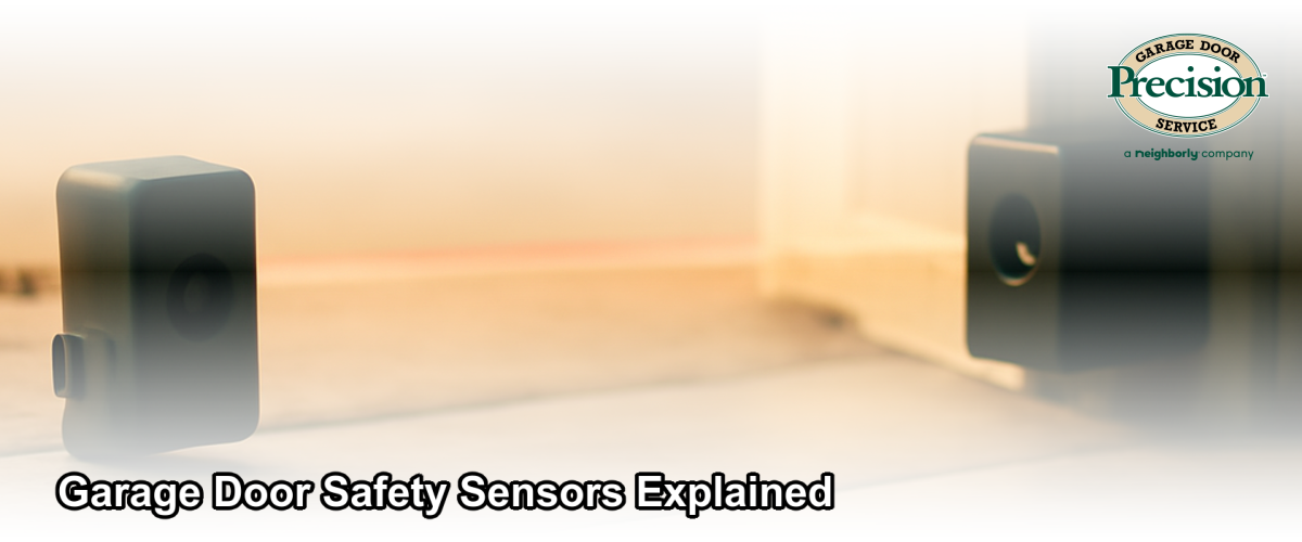 A close-up of a garage door photo-eye safety sensor mounted near the floor of a Chicago home garage, with a beam of light visible between the two sensor units.