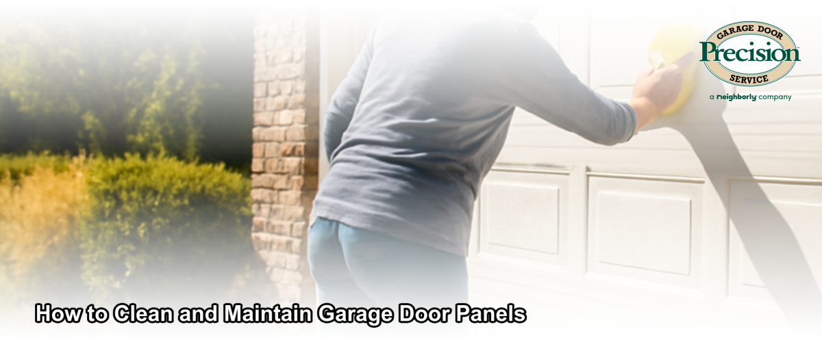 A homeowner cleaning a white garage door panel with a sponge and soapy water on a sunny Chicago day