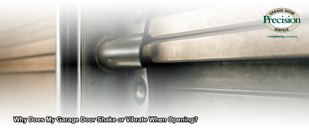 Close-up of a residential garage door track and roller showing signs of wear that can cause shaking or vibration when the door opens