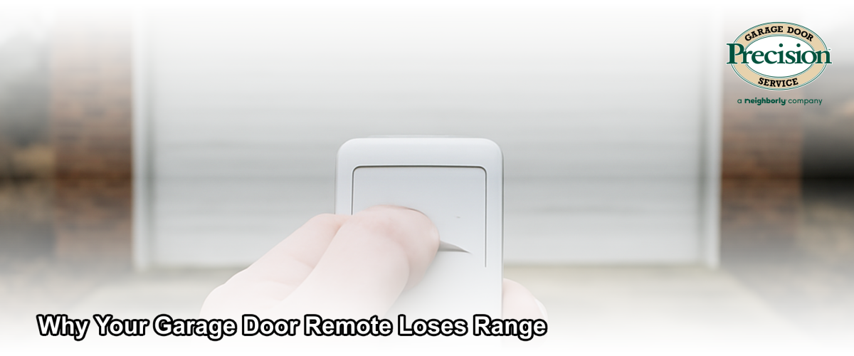 A hand holding a garage door opener remote pointed at a residential garage door in a Chicago neighborhood on a cold overcast day